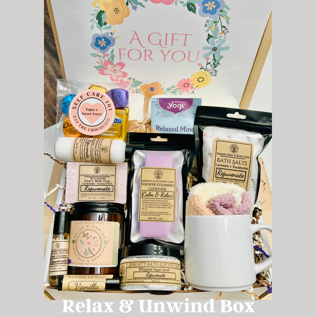 Gift box 'Relax & Unwind Box' with various items including a mug, candles, and bath salts.